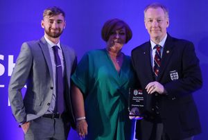 Wing Commander Neil Hope accepts the Joel Richards Inspire Award in memory of his daughter Charlotte. The award was presented by Joel's mum Suzy, and his brother Owen.