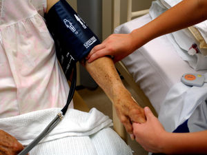 Anurse taking the blood pressure of an elderly patient at an NHS hospital in England. 