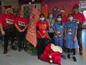 Supporting image for story: Knighton rugby team members deliver presents to children in Hereford hospital