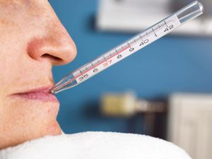 A woman with a thermometer in her mouth