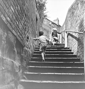 Youngsters running up the church steps at St Leonard's Church - one of Bridgnorth's many stairways, pictured in August 1960.