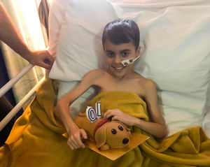 Alfie celebrating his 10th birthday on the hospital ward while undergoing treatment for medulloblastoma, an aggressive malignant brain tumour in children. (Photo: Children with Cancer UK)
