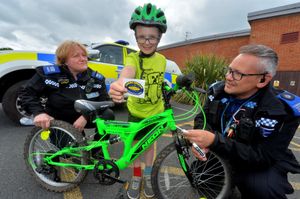 Police community support officers Shelley Hyde and Steve Breese helping Benedickt Michael Griffin mark his bike with Smartwater at Highley Community Day.
