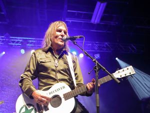 Mike Peters singing and playing guitar on stage
