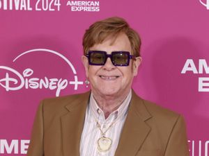 Elton John smiling at a premiere