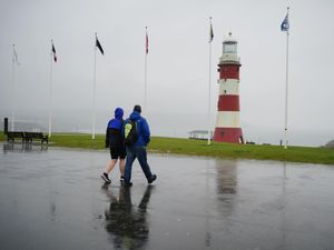People walking in heavy rain at Plymouth Hoe