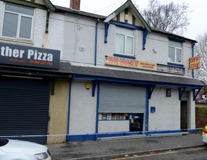 The flat above the Mini Mart shop remains cordoned off