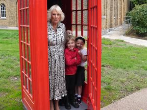 Supporting image for story: Queen bundles into phone box with schoolchildren as she visits gallery