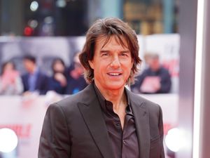 Tom Cruise smiling at a movie premiere