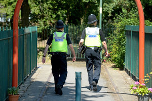 Police patrol the area in the aftermath of the killing