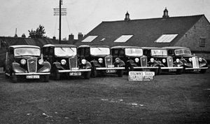 Line up of taxis including a Humber and Austins on the car park.