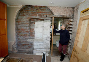 The original end wall of the house which the couple have rediscovered after it was covered