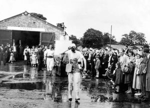Crowds watch some sort of parade.