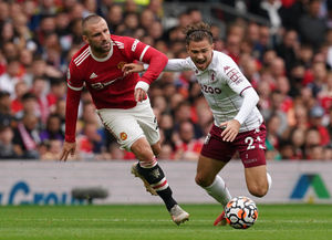 Manchester United's Luke Shaw (left) fouls Aston Villa's Matty Cash 