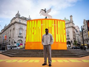 Supporting image for story: Artist Yinka Ilori transforms Piccadilly Circus with vibrant installation