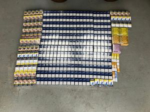 697 packs of cigarettes, 990 disposable vapes, 21 packs of hand-rolling tobacco and £3,000 in cash were seized