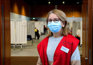 Volunteer Pam McPhillips helps to direct patients into the bays to get their jabs at Telford International Centre