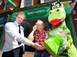 Supporting image for story: Town's charity running dragon hands Jenny a sweet thank you from Specsavers