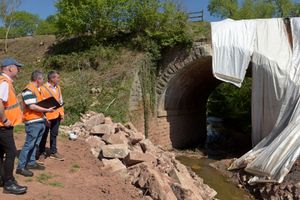 Gus Dunster, Antony Bartlam and Stuart Anderson MP inspect the damage at Mor Brook bridge. Photo: Garry Essex