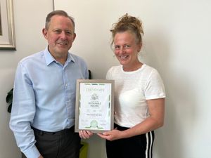Rob Gilham, Corporate Director of Strategy, Assets and Transformation and Jo Shields, Head of Sustainability and ESG with the certificate