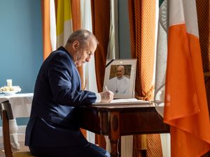 Micheal Martin signing a book of condolences