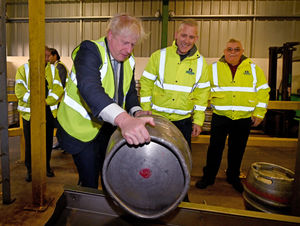 Former PM Boris Johnson tried his hand at loading a barrel onto the washer at Holden's Brewery