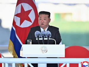 Kim Jong Un speaks during a launching ceremony of a new naval destroyer at a western port in Nampo, North Korea