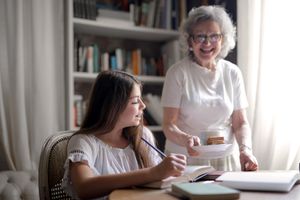 Foster parent helping a foster child with school work