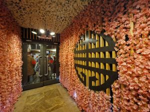 The entrance is adorned with cherry blossoms.