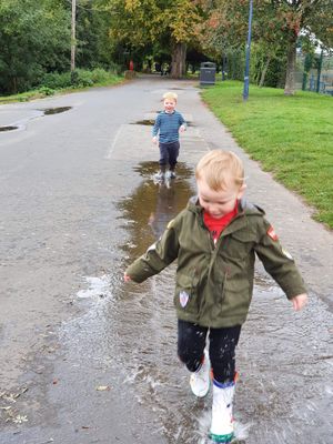 Noah and Dylan have fun splashing in puddles