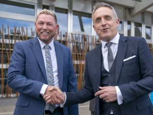 Jamie Greene and Alex Cole-Hamilton smiling and shaking hands