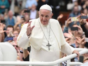 Pope Francis waves to crowds of people