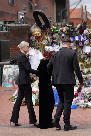 The family of Ozzy Osbourne (left to right) Kelly, Sharon and Jack Osbourne, view the messages and floral tributes