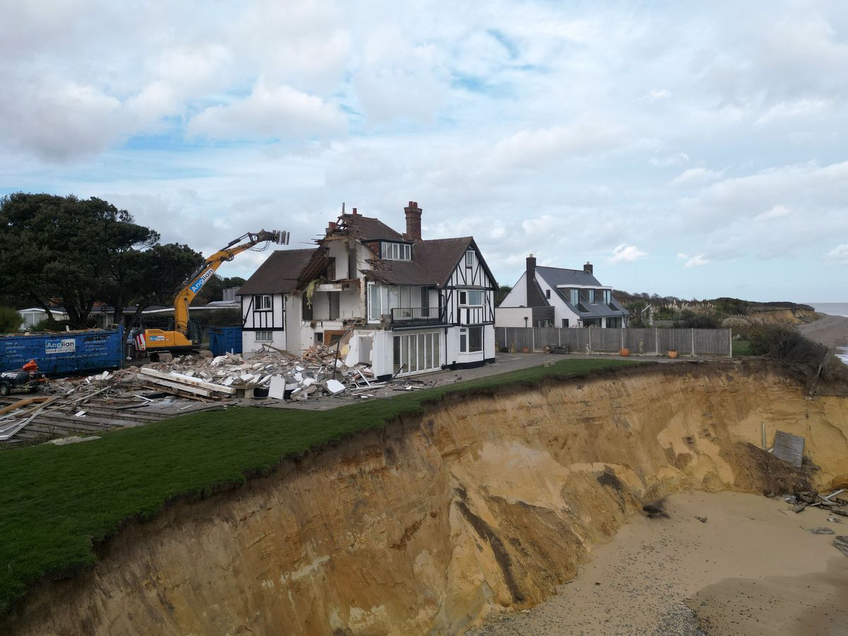 Demolition of fourth clifftop home at risk of falling into the sea begins