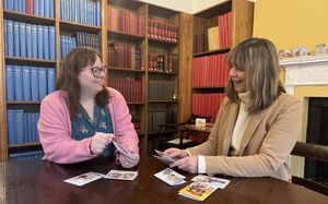 Councillor Hayley Coles with Staffordshire History Centre's Access and Engagement Manager Sarah English looking at the centre's collection of strange Victorian-era Christmas cards.