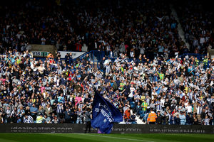 Fans wave their flags as players emerge ahead of kick-off. (Photo by Adam Fradgley/West Bromwich Albion FC via Getty Images)