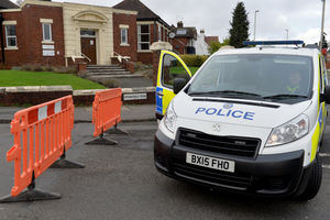 A police van blocks the entrance to Springfield Road