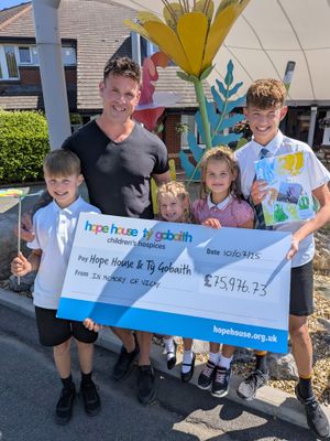 Matt Jones, aka Fridge Freezer Man, and his ‘Wolfpack’ present their fundraising cheque at Hope House. 
