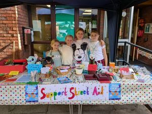 Supporting image for story: Children support Street Aid campaign for the homeless with fundraising stall