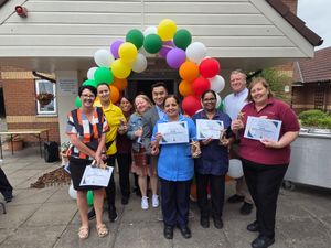 The long serving staff members gather to celebrate