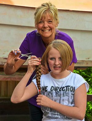 Ellie Thomas has her hair lopped off by Lyn Gardiner