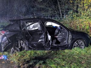 Supporting image for story: Crash photos show the scene after a two-vehicle road collision in Oswestry as firefighters use hydraulic equipment to free trapped casualty