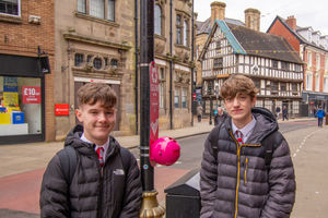 Marches School pupils Cian (left) and Seth with the new chewing gum bin outside Costa. Photo: Grum