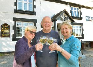 Graham Holroyd pictured with wife Ann, left and Chair of Community Group, Judith Griffin as the White Lion opens in Ash Magna.