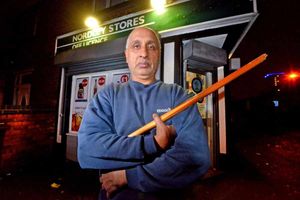 Balvinder Singh shows the stick he used to scare off the robber