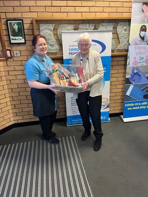 Cafe worker Tracy presents Betty’s prize
