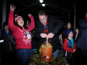 Kington Chamber of Trade Chairman Emma Hancocks cheers as post master Tim Allen pushed the plunger to switch on the Christmas lights. Image: Andy Compton