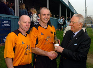 Charity football at Halesowen, Express & Star V Midland All Star XI. Man of the match Duncan Rose (middle) with his bottle of wine presented by Peter Creed (right) and one of the organiser Roy Williams.