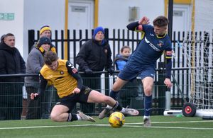 Callum Coyle and Jake Dye battle for the ball
