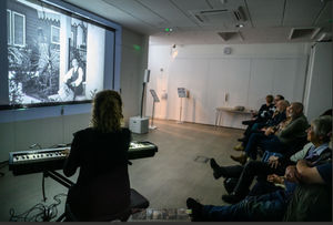 An audience enjoying a Pocket Film Festival screening featuring a music accompaniment